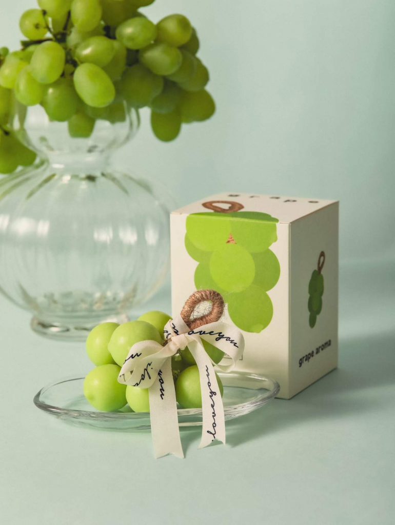 Handcrafted green Shine Muscat grape cluster soy candles with custom ribbon ties by Custom Candle Craft