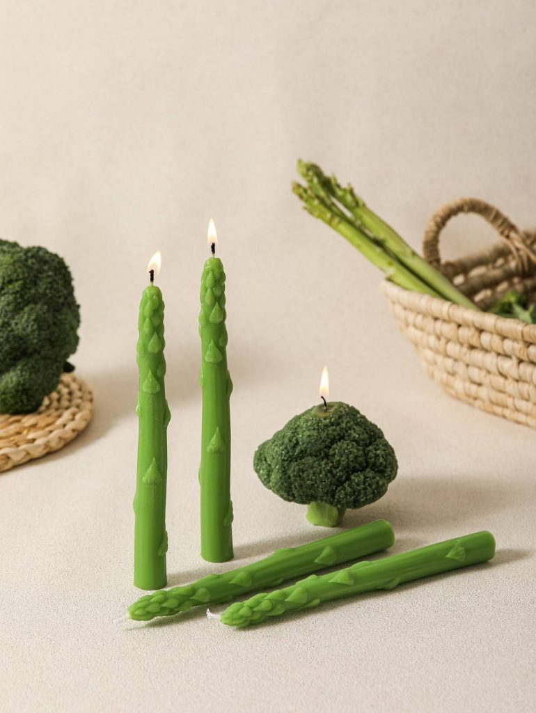 Aesthetic green taper candles and vegetable soy candles on fine dining table setup