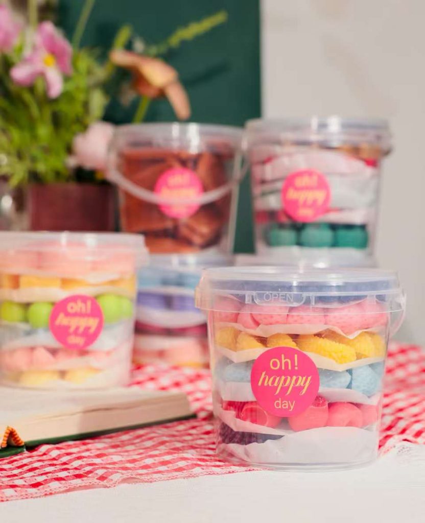 Clear plastic bucket container filled with custom novelty soy wax melts by Custom Candle Craft