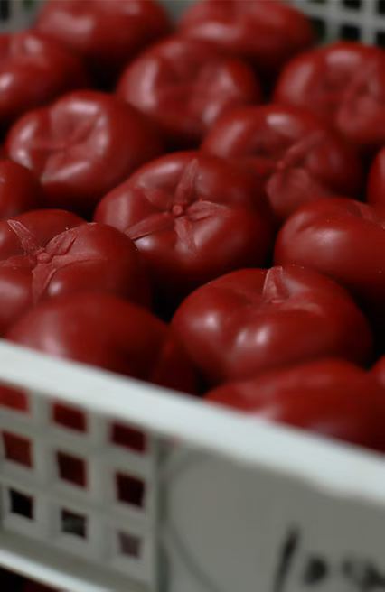Factory packing crate loaded with bulk red apple and tomato soy candles for export shipping
