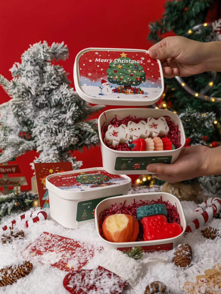 Hands holding custom Christmas tin bento box soy candle gift sets for private label OEM