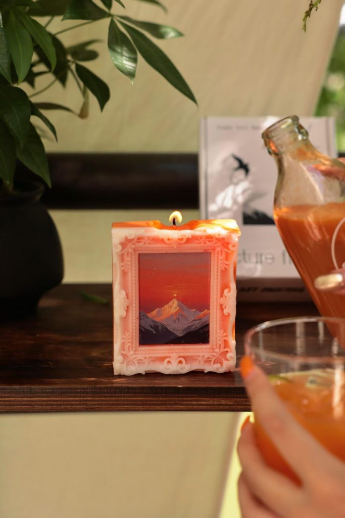 Lit orange mountain sunset oil painting picture frame soy candle for aesthetic room decor