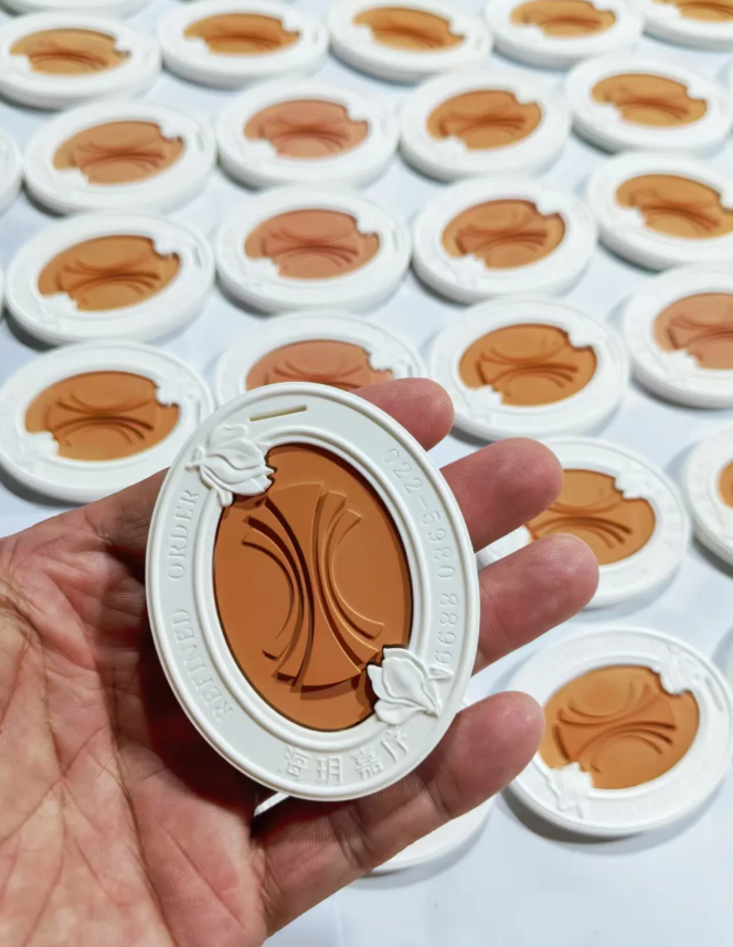 Terracotta and white oval plaster aroma diffuser stone with custom silicone mold relief in hand
