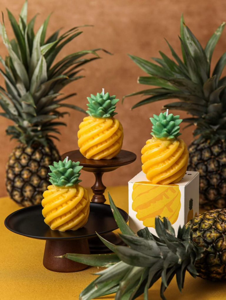 Tropical yellow pineapple shaped soy candles crafted with custom silicone molds