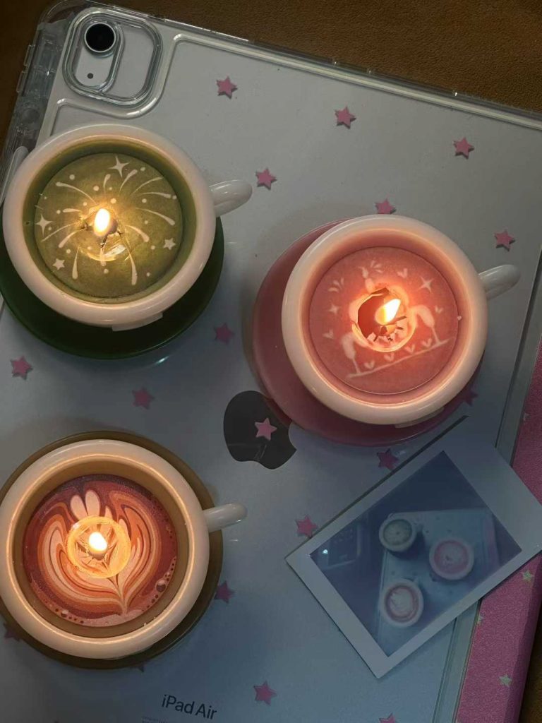 Top-down view of burning ceramic espresso cup soy candles with clean wax melt pool and lead-free cotton wicks.