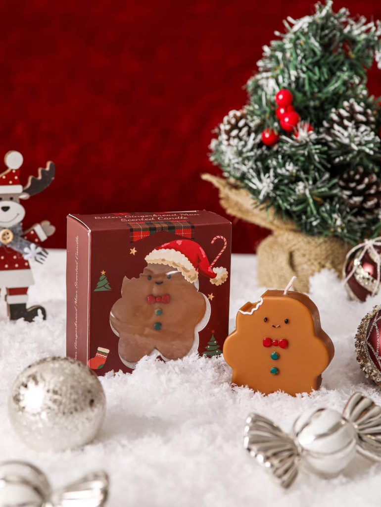 Wholesale novelty bitten gingerbread man scented soy candle with bespoke Christmas window gift box by BSCI candle factory.