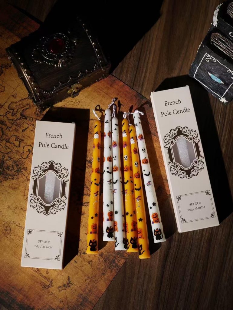 Custom printed Halloween taper candles featuring bats pumpkins and ghosts in luxury vintage window packaging boxes.