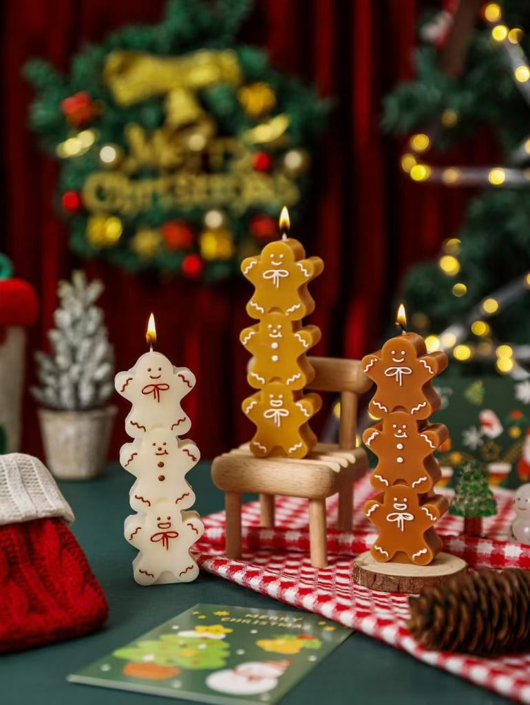 Handcrafted multi-tiered stacked gingerbread man totem pillar soy candles for holiday home decor wholesale.