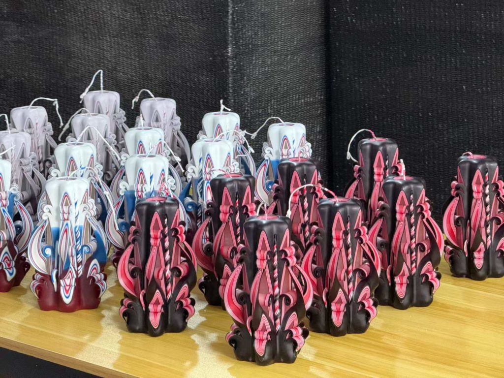 Batch of gothic black and deep burgundy hand carved baroque candles manufactured by Custom Candle Craft