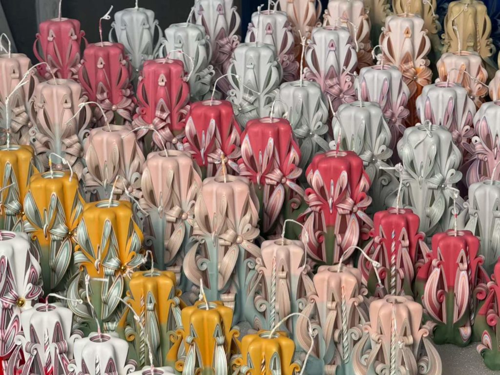 Mass production workshop array of wholesale hand carved baroque pillar candles in assorted colors